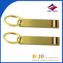 Very simple gold metal key chain with red white black color